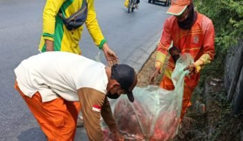 Photo: Petugas UPTD Kebersihan bekasi utara saat melakukan bersih bersih di jalan raya teluk pucung KCM (Doc.Ist) 